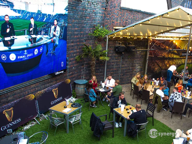 hennessey outdoor TV screen in a pub garden